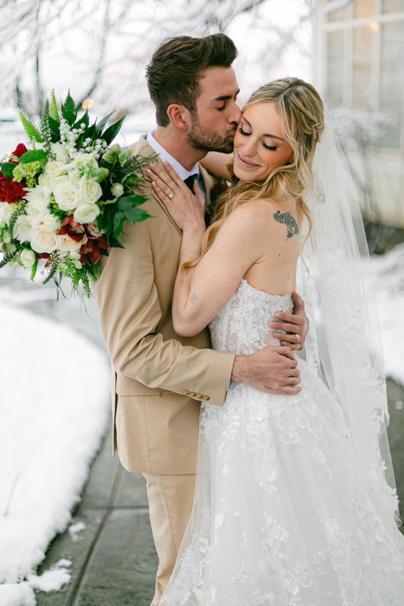 Updated text: A bride and groom celebrate their wedding on a snowy day near Salt Lake City Utah